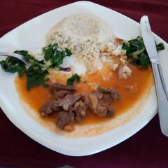 A picture of Rice pillaf with beef stew and saute spinach.