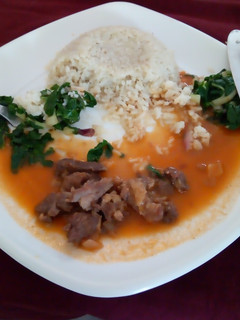 A picture of Rice pillaf with beef stew and saute spinach.