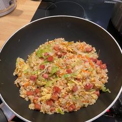 A picture of Fried rice with spam, egg and lettuce.