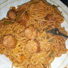 A picture of Tasty fried indomie noodles with sausages.