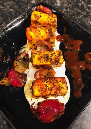 A picture of Basil Paneer Tikka Masala and mint yoghurt.