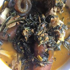 A picture of Bitter leaf soup with assorted meat.