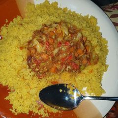 A picture of Fried cous cous with vegetable and shredded beef stew.
