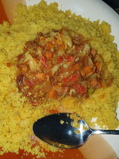 A picture of Fried cous cous with vegetable and shredded beef stew.