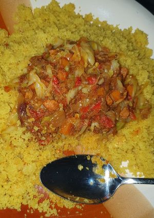 A picture of Fried cous cous with vegetable and shredded beef stew.