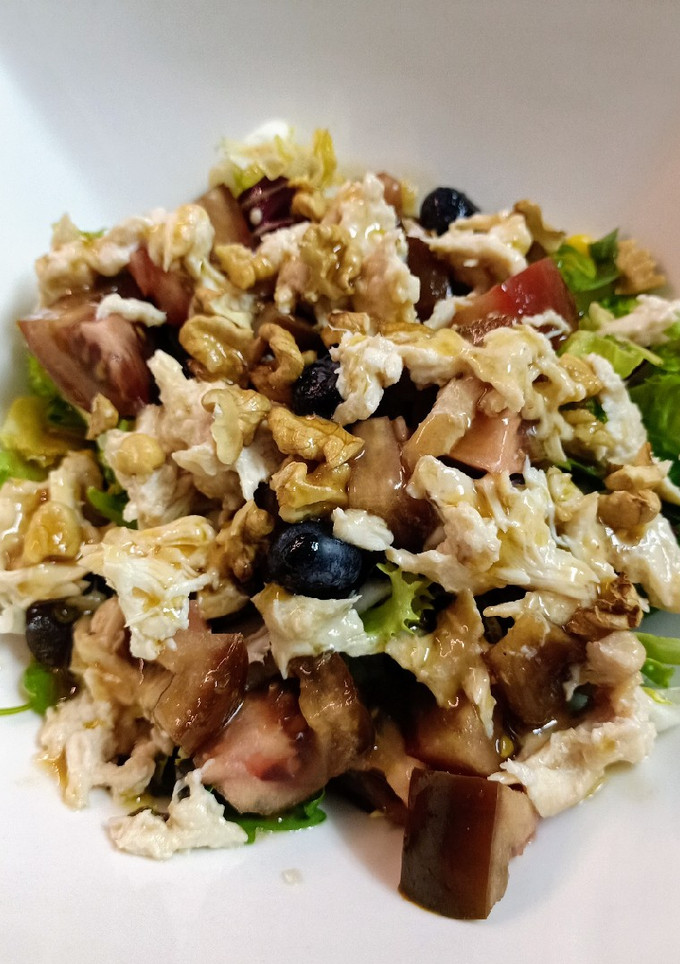 Una foto de Ensalada de brotes tiernos, pollo asado y arándanos