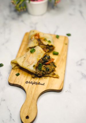 A picture of Savoury crepe with minced meat fillings.