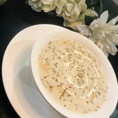 A picture of Cream of mushrooms and sausages soup.