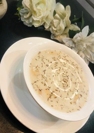 A picture of Cream of mushrooms and sausages soup.