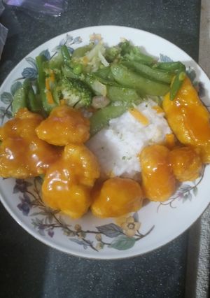 A picture of Orange Chicken Asian Veggies Over Rice.