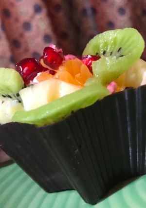 A picture of Chocolate Cups filled with Pastry Cream and Fresh Fruits.