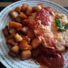 Cajun Chicken Parm with sauteed garlic potatoes A picture of Cajun Chicken Parm with sauteed garlic potatoes.