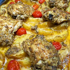 A picture of Greek-style roasted herb chicken and lemon potatoes.