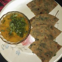 A picture of Dhania parantha with aloo tamatar ki rasedar sabji.