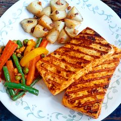 A picture of Peri-Peri Paneer Steaks with Tossed Vegetables.