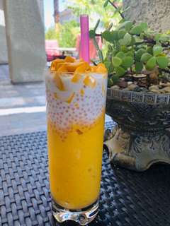 A picture of Mango slush with sago (tapioca pearls) and coconut milk.