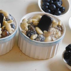 A picture of Fruit bowl with berries, banana, and Greek yogurt.