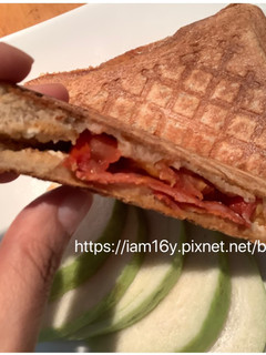 A picture of [Breakfast] Sausage and Cheese Grilled Sandwich with Olive Oil Marinated Tomatoes.