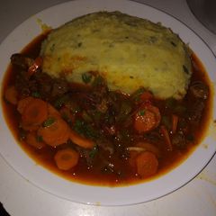 A picture of Mashed potatoes with beef stew.