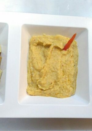 A picture of Hummus with baked namken and garlic bread.