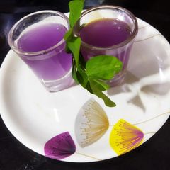 A picture of Butterfly pea lemon Mocktail.