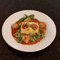 A picture of Angel Hair Alfredo "Cakes" with Marinara Sauce and Sausage.