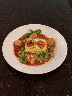 A picture of Angel Hair Alfredo "Cakes" with Marinara Sauce and Sausage.