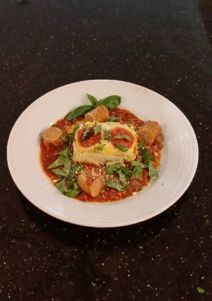 A picture of Angel Hair Alfredo "Cakes" with Marinara Sauce and Sausage.