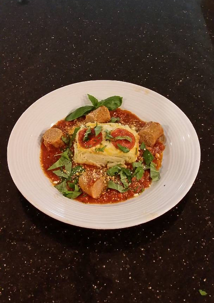 A picture of Angel Hair Alfredo "Cakes" with Marinara Sauce and Sausage.