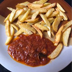 A picture of Irish potatoes and tomatoes sauce.