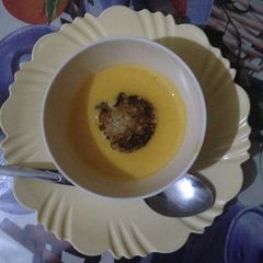 A picture of Pumpkin soup served with bread.