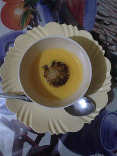 A picture of Pumpkin soup served with bread.