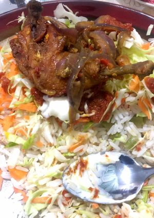 A picture of Rice and stew with pepper chicken.