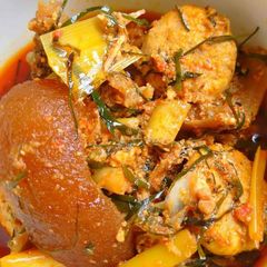 A picture of Egusi soup with achara and ukazi leaves.
