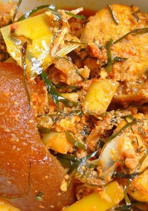 A picture of Egusi soup with achara and ukazi leaves.