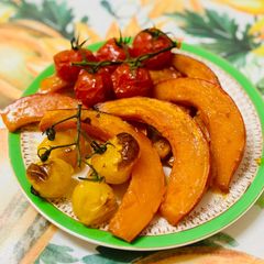A picture of Pumpkin in the oven with tomatoes.