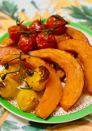 A picture of Pumpkin in the oven with tomatoes.