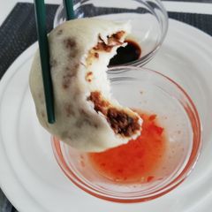 A picture of Bao buns with spicy filling.