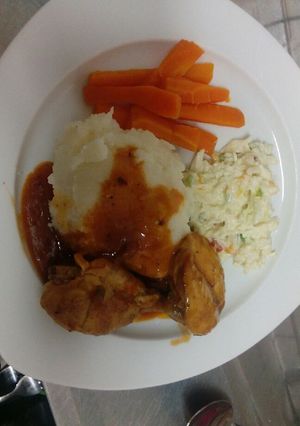 A picture of Mashed potatoes and chicken.