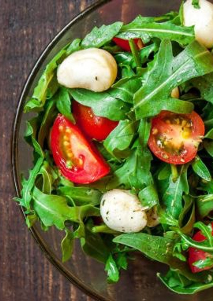 Una foto de Ensalada de tomate, mozzarella, lechugas y albahaca