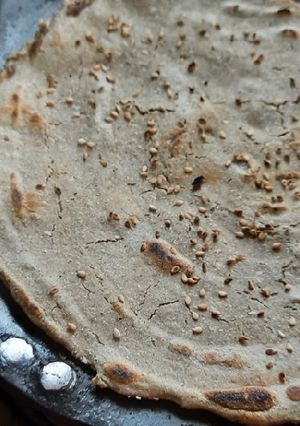 A picture of Bajra Bhakri with seasome seeds.