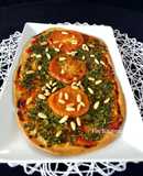 Pizza de espinacas tomate y piñones