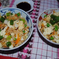 A picture of Rice with salmon fish and vegetables.