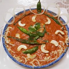 A picture of Shahi Kaju Chilli Moghlai Curry.