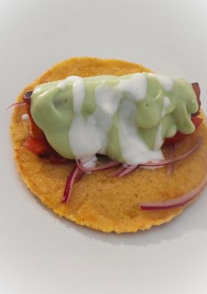 A picture of Salmon Taco with Avocado Cream.