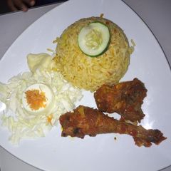 A picture of Jallof Rice and pepper chicken.