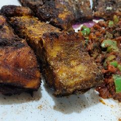 A picture of Fried fish with tomato chutney.