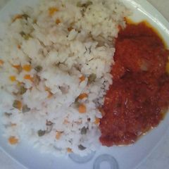 A picture of Rice with mixed vegetable with chicken stew.