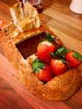 Chocolate fondue breadboat with strawberry