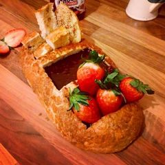 A picture of Chocolate fondue breadboat with strawberry.